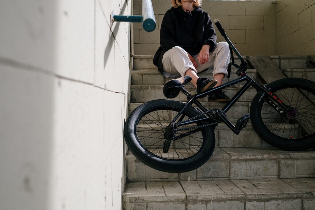 Person in Black Jacket Sitting on Stairs